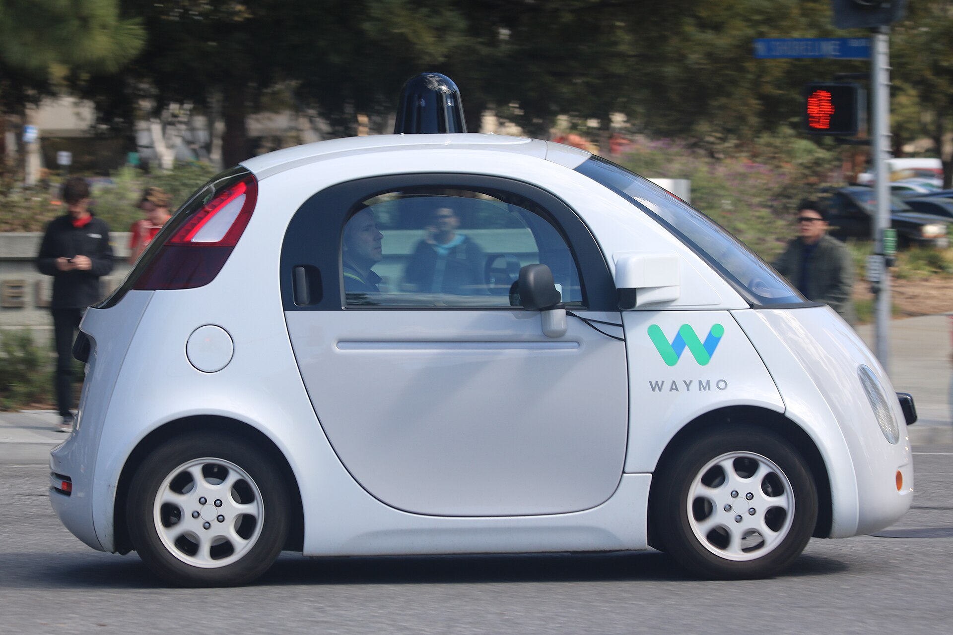 A Waymo self-driving car on the road in Mountain View, making a left turn. (Side view.)