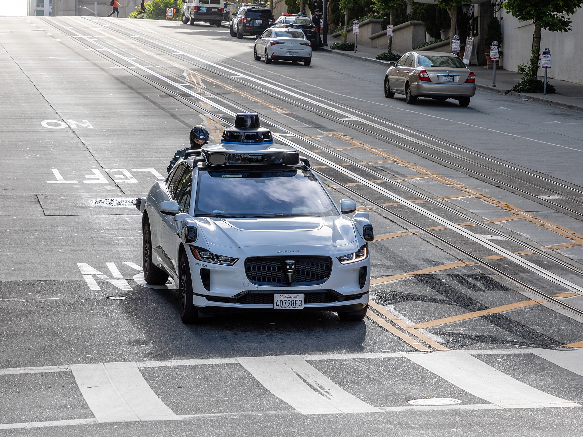 A Waymo robotaxi on public roads — one of the autonomy threads in today's Reddit roundup.