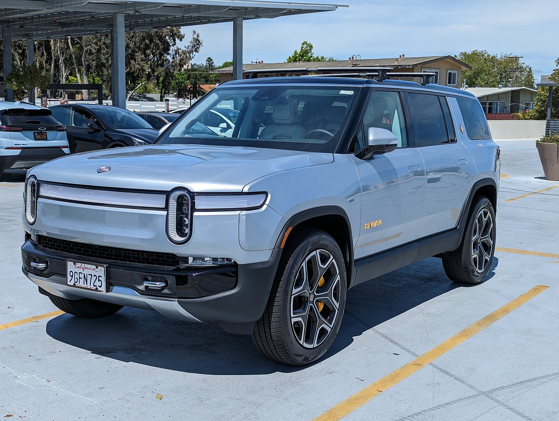 A Rivian R1S electric SUV parked in a lot, the model owners are tracking the 2026.15 over-the-air update on.